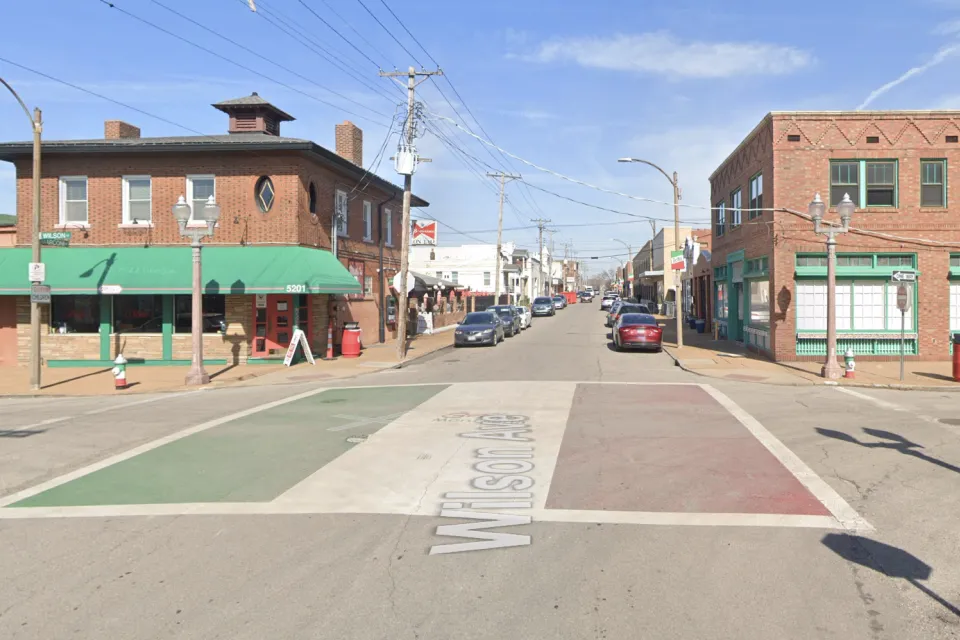 An intersection is adorned with paint depicting the Italian flag in St. Louis.